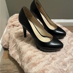 Nine West classic black pumps with 4 inch
heel and 1/2 inch platform.